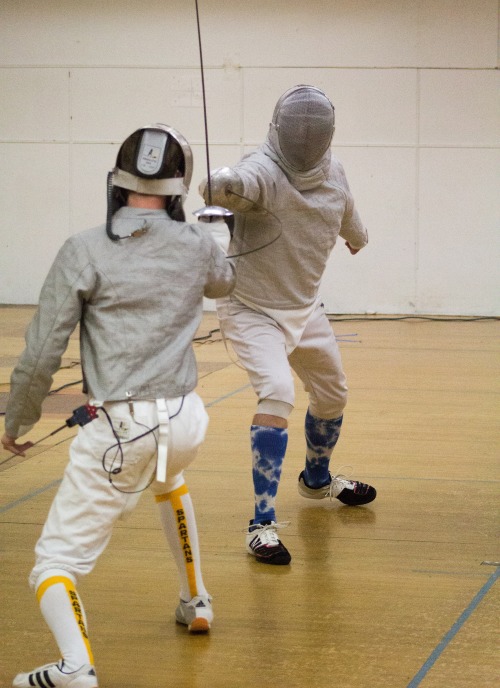 modernfencing: [ID: a sabre fencer hitting his opponent in the wrist. His blade is bending into an a