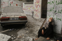 troposphera:  A Palestinian woman sits in