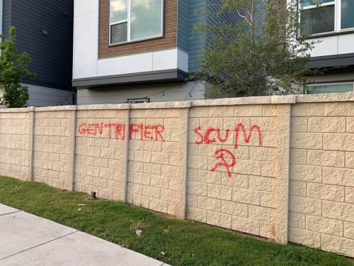 “Gentrifier Scum”Painted on the wall outside a row of new yuppie condos in Austin, Texas
