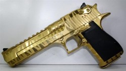 gunrunnerhell:  Desert Eagle XIX A titanium gold tiger striped finish Desert Eagle chambered in 50 Action Express. Interesting to note that the current XIX models for those chambered in 50 AE reverted back to the “tear-drop” shaped safety instead