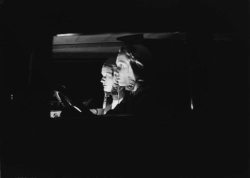 Zoltán Glass -Two women, viewed side-on, in a car at night, 1932.