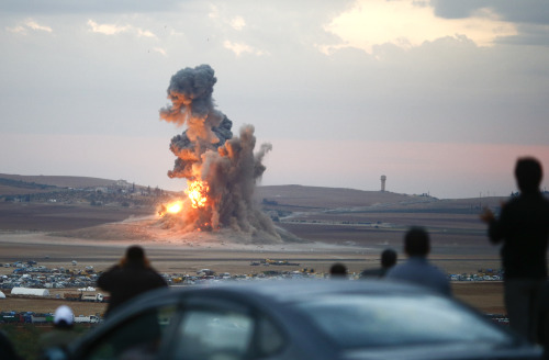 dig-image:  Smoke and flames rise over a hill near the Syrian town of Kobani after an airstrike, as seen from the Mursitpinar crossing on the Turkish-Syrian border in the southeastern town of Suruc in Sanliurfa province, October 23, 2014. (Photo by Kai