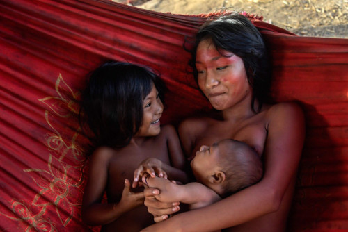 Meri, a Waiapi woman, snuggles with children at the tribe&rsquo;s village in Brazil&rsquo;s Amapa st