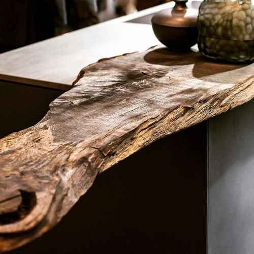 A slab of reclaimed wood serves as an extended countertop for serving, temp storage, but not sure ab