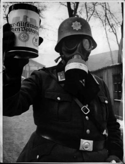 historicaltimes: A uniformed member of the Reichsluftschutzbund fundraising for the German Winter Relief fund. Date unknown. via reddit 
