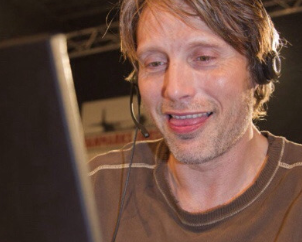 phoneus: catmom-emmy:   phoneus: does anyone have that pic of actor mads mikkelsen biting his tongue in an impish smile and typing on a tan computer maybe?   me logging in to make cum jokes 