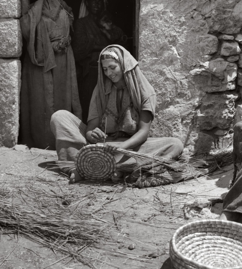 1001arabianights: Woman weaving reed baskets. Bethlehem, Palestine.1946