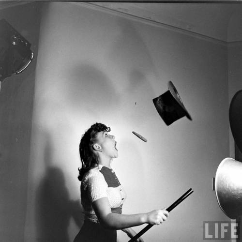 Yvette attempts to catch both the flipped cigar and top hat(Nina Leen. 1942?)