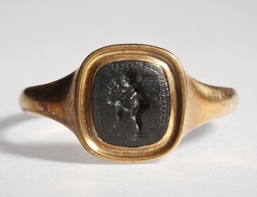 flaubertian:Eros, pouring wine into a drinking bowl. Graeco-Roman ringstone, 30 BC - 200 AD.