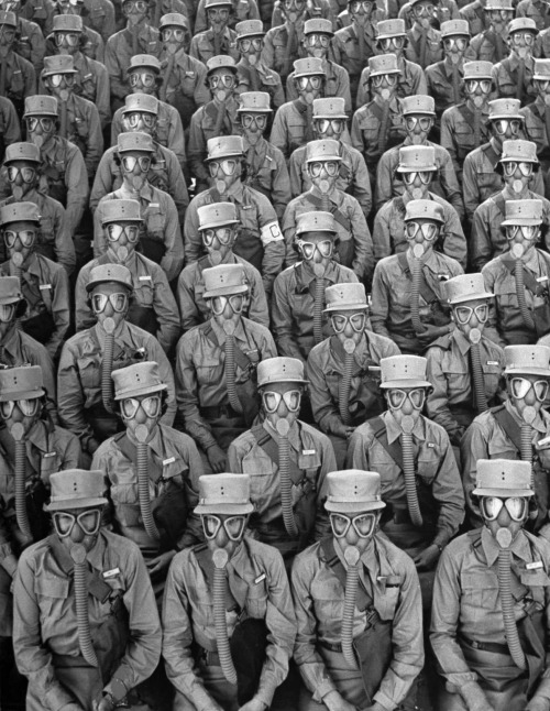 Marie Hansen - Row upon row of WACs (Women’s Army Corps members) don gas masks for a training drill at Iowa’s Fort Des Moines, 1942.