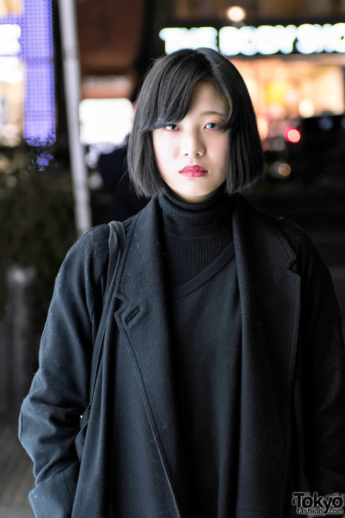 19-year-old Moeno on the street in Harajuku wearing a dark look including a Christophe Lemaire maxi 