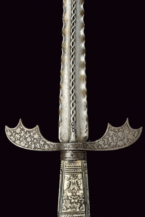 art-of-swords:  Engraved DaggerDated: 17th  centuryCulture: GermanMeasurements: overall length 51.5cmThe dagger has a straight, flame-shaped blade, on a side a strong raiser worked with woven chiselling, and the tip shaped as an arrow. The quillon is