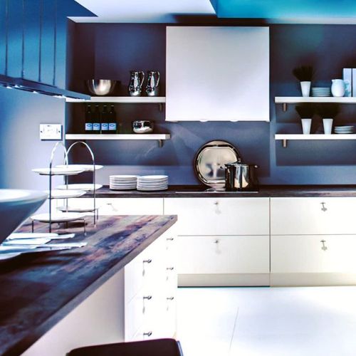 It’s modern yet with a few touches of warmth. The textured countertop and open shelving with u