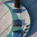 thepit:bleachedvi0let:Crucianelli Spazial 1965 Crecent Moon guitar 🌙[ID:4 pictures of an electric guitar taken from various angles. Its body is in the shape of a crescent. It’s light blue with a white pickguard. It has a vibrator arm/End ID]