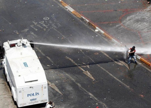 occupygezipics:A protester against water canon earlier today in Taksim