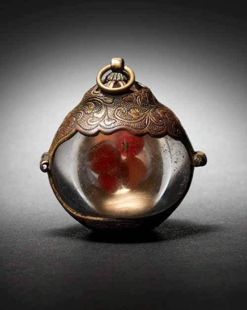 japaneseaesthetics:A Buddhist rock crystal reliquary containing carnelian agate beads, the hinged mo