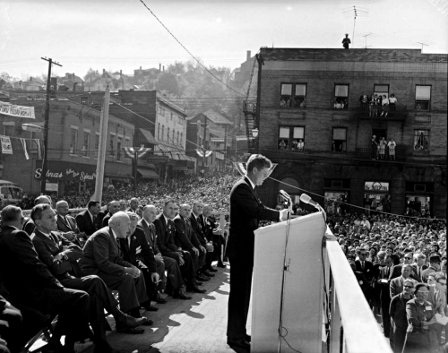 historicaltimes:President John F. Kennedy speaking from podium, with Senator Joseph S. Clark and Pen