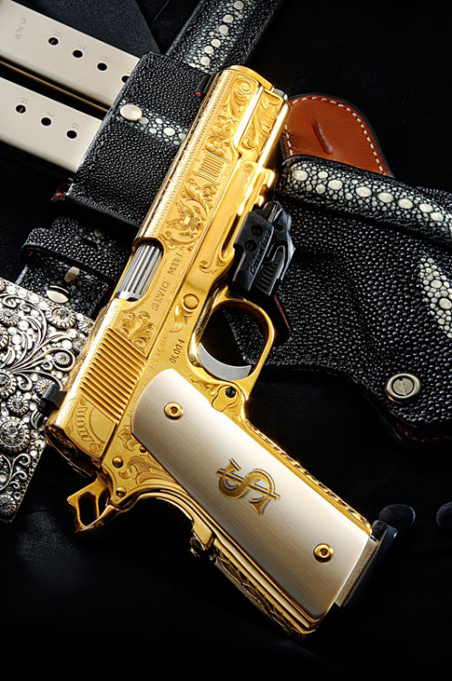 gunrunnerhell:  United States of AmericaGold plated and engraved custom 1911 from DL Sports, not much other info on it. Serial number 4 but I don’t know how many they made total or if they’re a custom made-to-order pistol. No price is mentioned either.