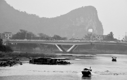 Bridge over the Li River with Moon Hole Hill in the background, located in Guilin, China.