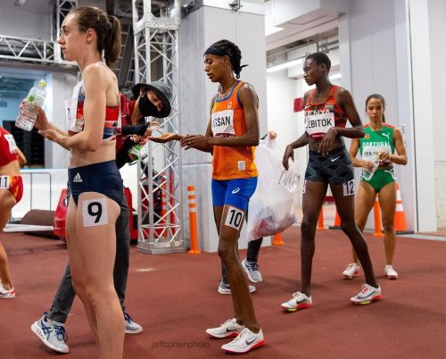 Sifan Hassan, NED, gets some hand sanitizer from a Tokyo 2020 volunteer, while waiting in the tunnel