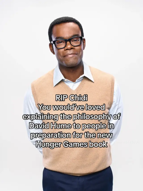 A picture of Chidi Anagonye with glasses on, wearing a longsleeve two-color shirt, hands behind his back, smiling. There is text over it that reads "RlP Chidi You would've loved explaining the philosophy of David Hume to people in preparation for the new Hunger Games book"
