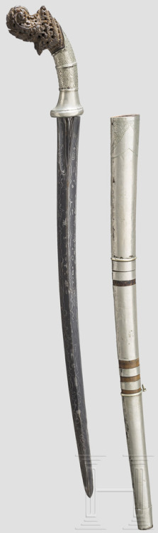 Malaysian klewang with carved hilt and silver mounts, scabbard. Circa 1900.from Hermann Historica