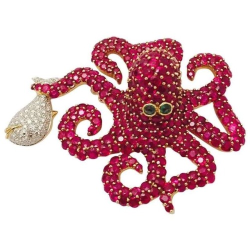 This fun brooch by Marvin Katz features rubies, diamonds, and emeralds. It is available from Classic