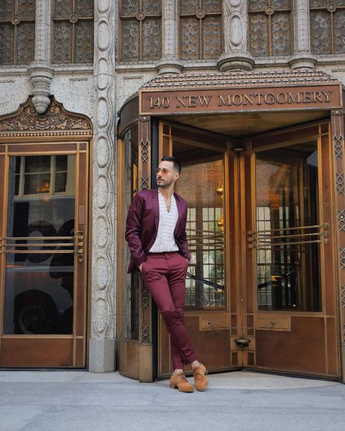 A burgundy suit with a patterned shirt and statement eyewear is a recipe for a fun time (no matter w
