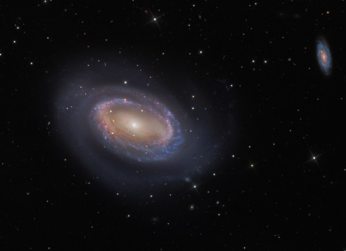 While most spiral galaxies have two or more arms, NGC 4725 only has one.  In both photos, a more tra