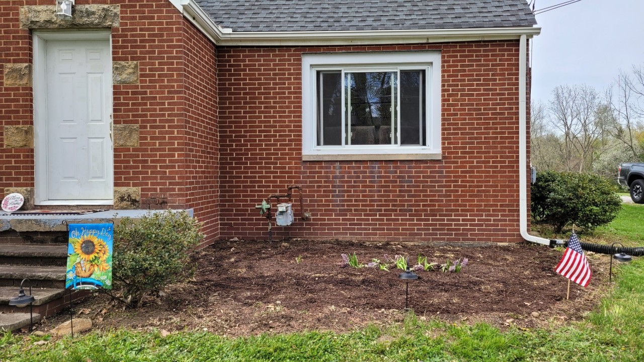 katiiie-lynn:It’s not the prettiest presentation because it still needs work, but spent all day outside weeding the flower beds and finally laying down some mulch. Planted some lilacs outside our reading room windows, planted grass seed by our A/C