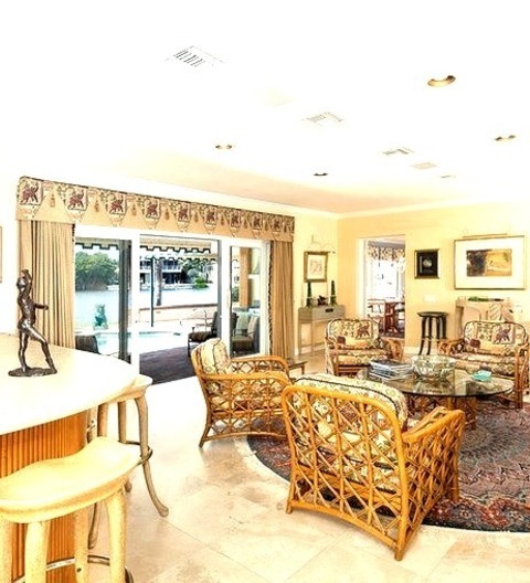 Tropical Family Room In MiamiExample Of A Mid-sized Island Style Loft-style Porcelain Tile And Beige