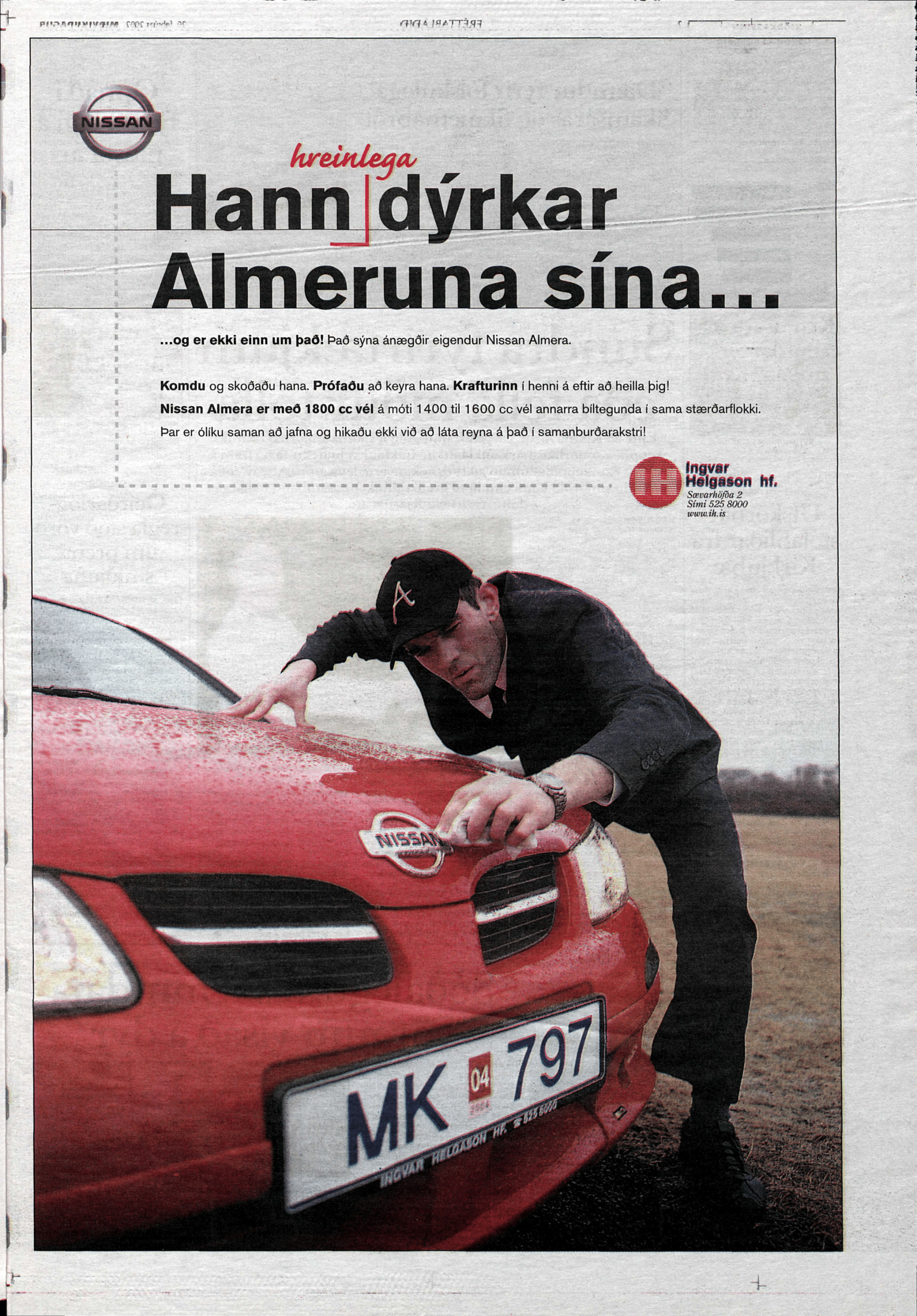 Stefán Karl meticulously cleaning a red nissan almera