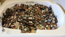 swagarian:  A guest at my friend’s hotel left these behind   Yes, that is a four-person jacuzzi filled with magic: the gathering cards