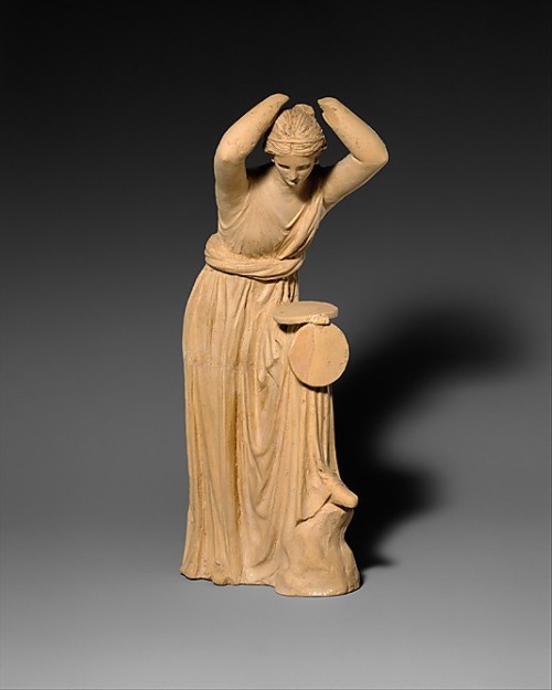 ancientpeoples:Terracotta Statue of a Woman looking into a Box Mirror300-200 BCHellenisticThis woman