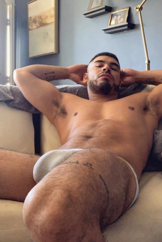 italianthongguy: justthewayitisworld:   dappereroticsexy:    Dude so Damn sexy    Thoughtful of him to give you something to read as you work your way up to that mouthwatering bulge! 