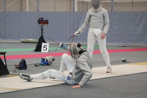 [ID: three photos of a sabre fencer retreating, lying down on the strip, and then getting up again, 
