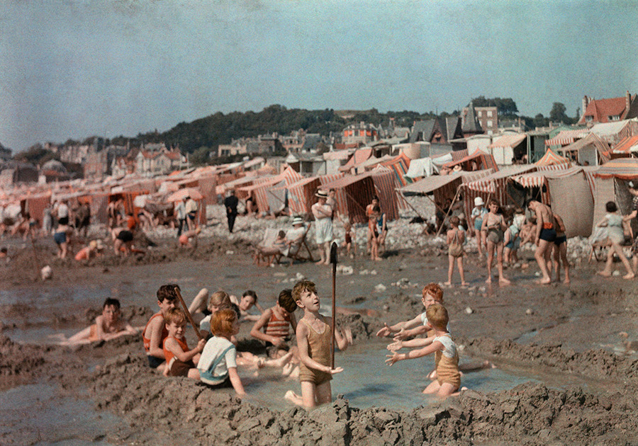 natgeofound:  Children play in pool they have dug out of the sand on the beach in