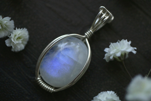 Close up of my latest sterling silver pendants - agatized fossil coral and rainbow moonstone. They&r