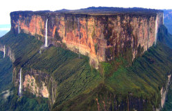 jezebuilt:  sixpenceee:Mount Roraima, South America: This tabletop mountain is one of the oldest mountains on Earth, dating back two billion years when the land was lifted high above the ground by tectonic activity. The sides of the mountain are sheer