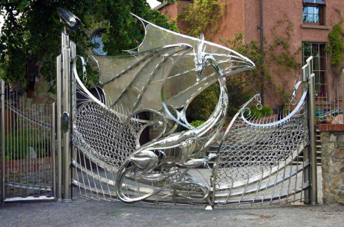 hideback:  Dragon’s Gate, Harlech House Goatstown, Dublin, Ireland. Curved Stainless Steel with Glass Eyes. Started circa 1993. Harlech House is a 7-bedroom estate built in 1798. Incredibly elaborate steel ornaments adorn the entire property, including