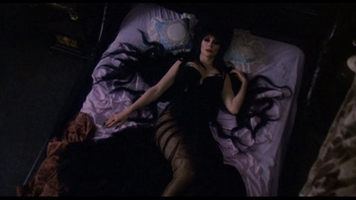 She’s even perfect while she sleeps. Cassandra Peterson as Elvira in Elvira: Mistress of the Dark (1