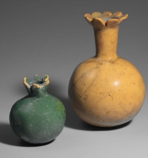 ca. 1295-1050 BCE. Pomegranate Shaped Bottles, opaque glass. The small green unopened shape held the