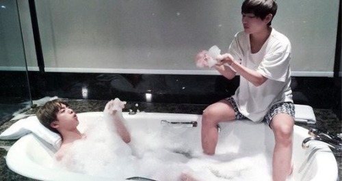 two bros chillin in the hot tub, two feet apart cause they’re not gay