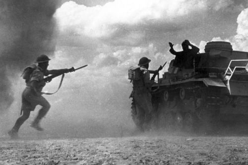 ww2inpictures:Commonwealth soldiers rush towards a German Panzer III medium tank with bayonets drawn