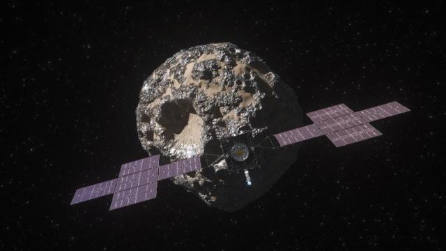 Space provides a dark backdrop for this image, with small twinkling stars dotting the background. At the center of the image is the artist’s illustration of the Psyche asteroid with deep craters and metal all around. The Psyche spacecraft is in the front, with the main body in the middle of large solar arrays on each side. Credit: NASA/JPL-Caltech/ASU