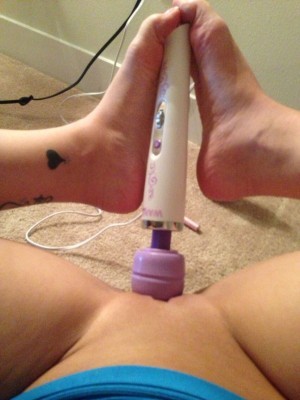 her toes are curled for 2 reasons - because it feels good and she has to hold the vibrator