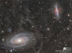 just&ndash;space:  Galaxy Wars: M81 versus M82   : In the lower left corner, surrounded by blue spiral arms, is spiral galaxy M81. In the upper right corner, marked by red gas and dust clouds, is irregular galaxy M82. This stunning vista shows these two