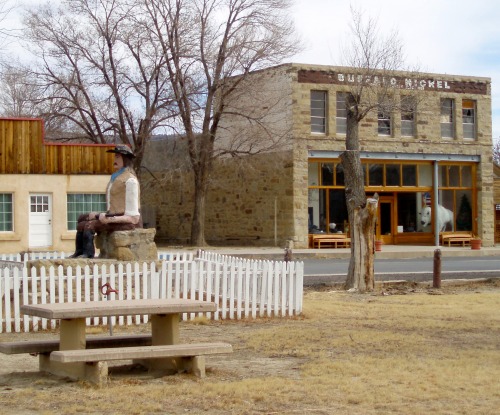 Cowboy Statue and Buffalo Nickel With Bison in the Window, Cimarron, New Mexico, 2006.