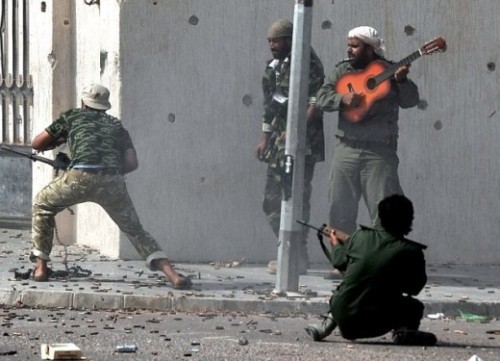 thearkanproject:Rebel plays guitar in Libya war