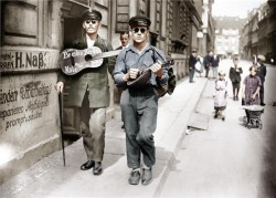 Two street musicians that lost their sight in World War I in Berlin (colorized). They traveled on foot from Breslau to Hamburg via Berlin, Cologne, and Amsterdam. (c. 1920)